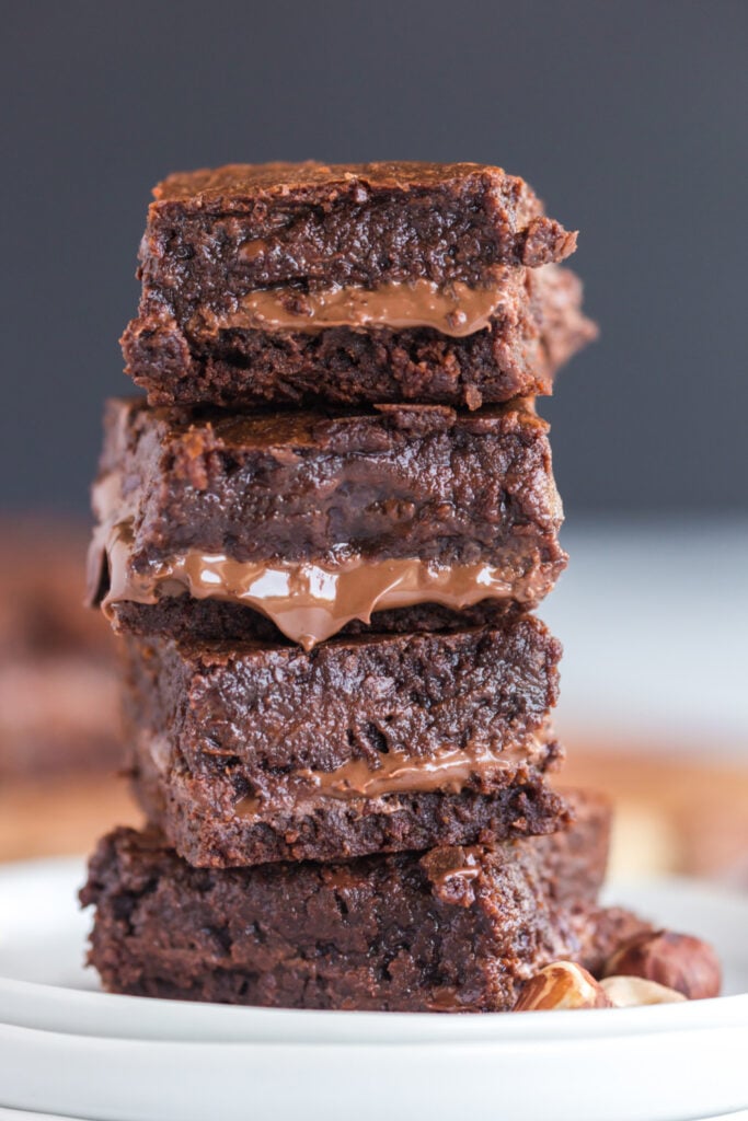 Nutella Stuffed Brownies stacked on a plate