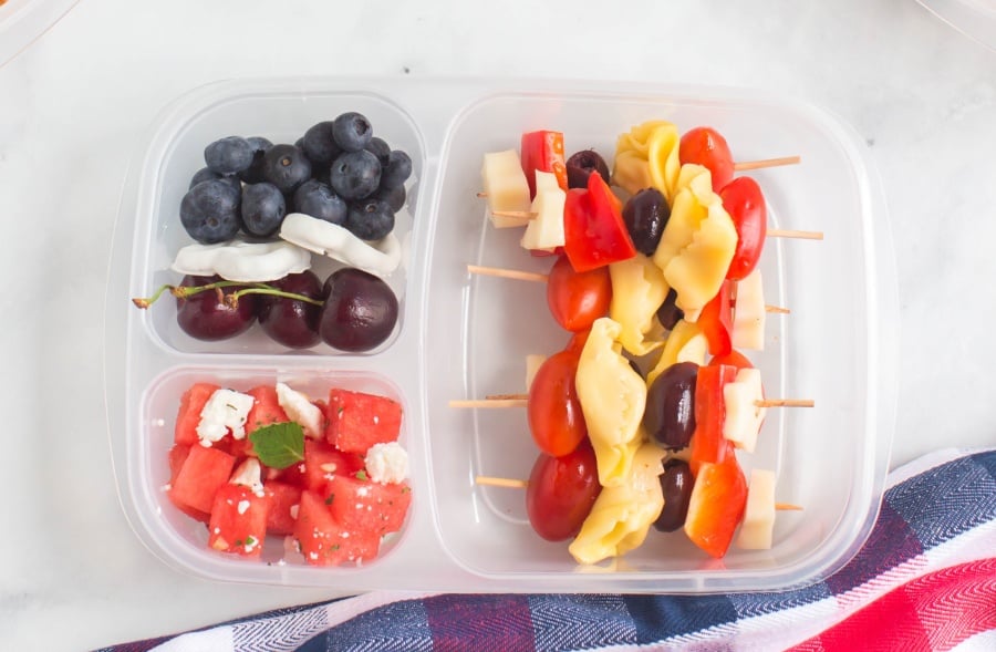 pasta salad skewers, and fruit packed in a lunchbox