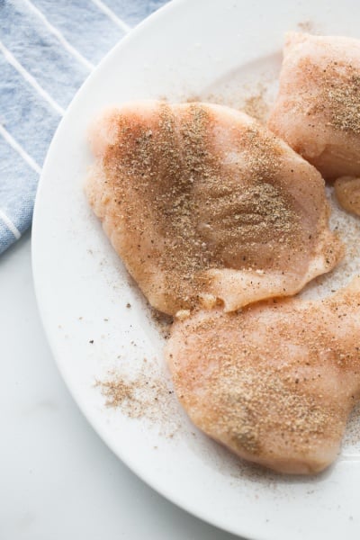 chicken breasts seasoned on a plate