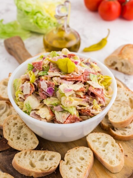 Italian Hoagie Dip in a bowl with sliced baguettes