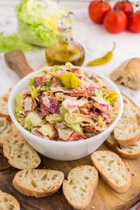 Italian Hoagie Dip in a bowl with sliced baguettes