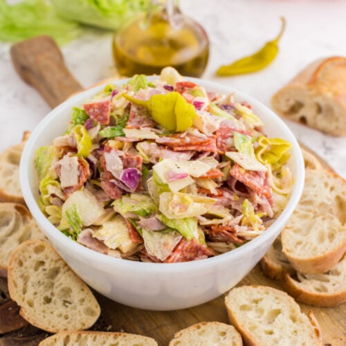 Italian Hoagie Dip in a bowl with sliced baguettes