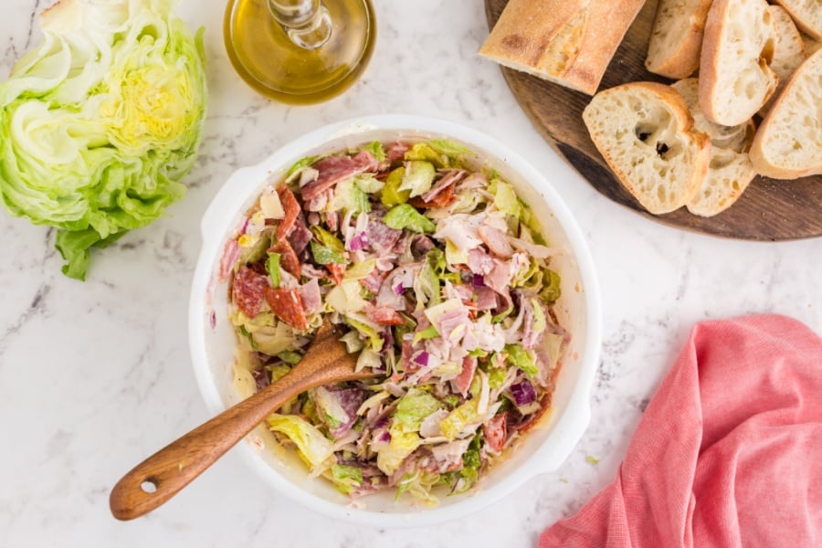 dressing mixed into dip ingredient with wooden spoon