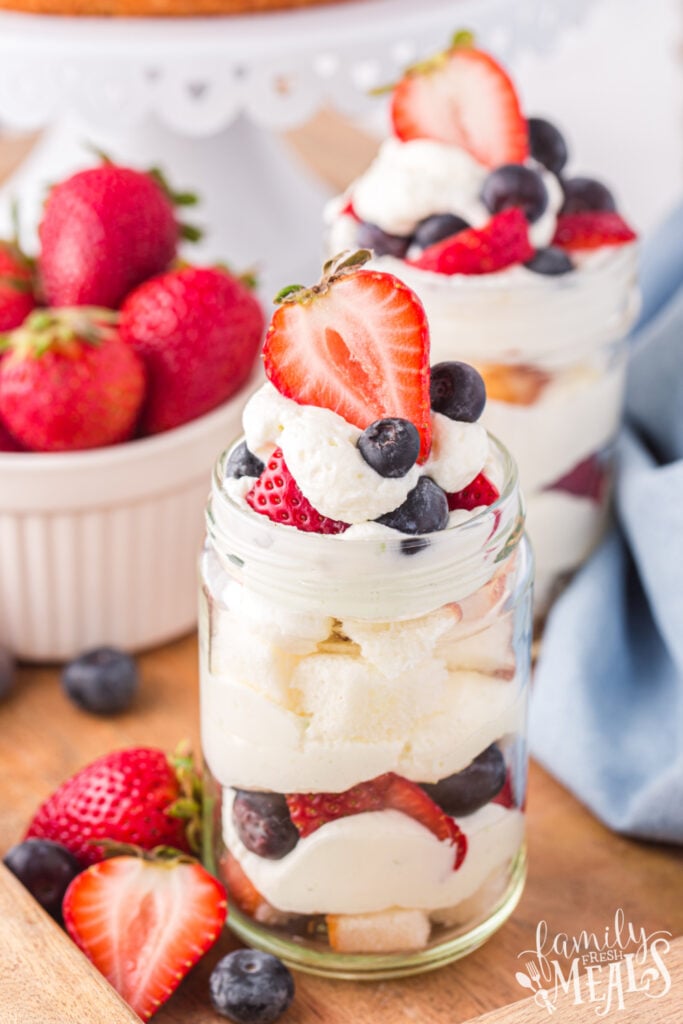 3 mason jar July 4th Angel Food Cake Trifle with a bowl of berries
