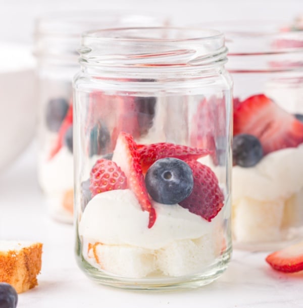 angel food cake cubes, cream cheese mix and berries in a mason jar