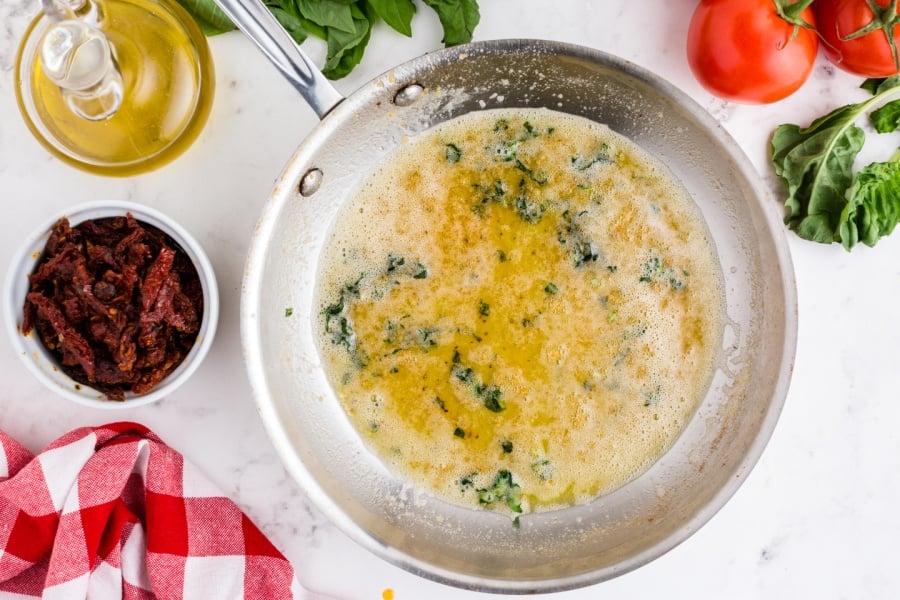 melted butter and herbs in a pan