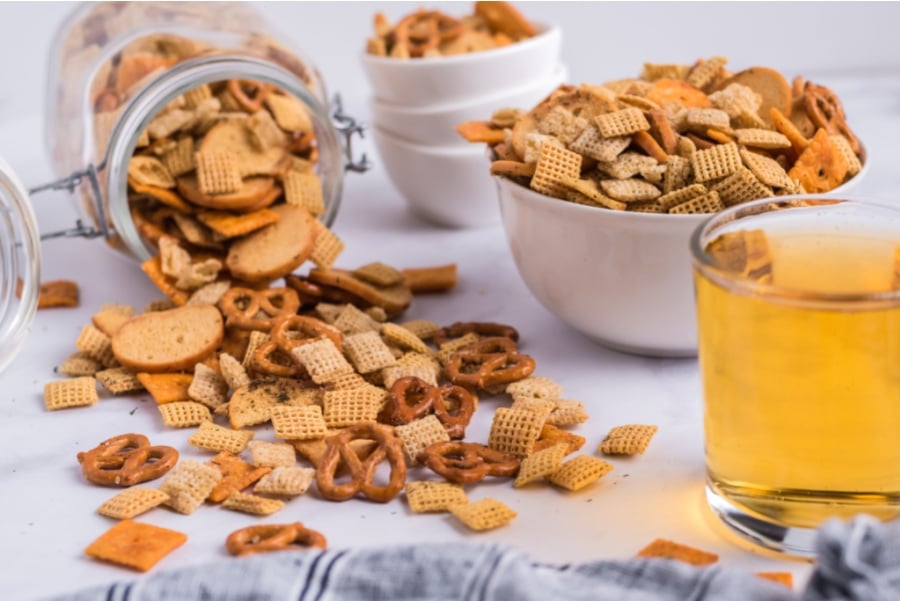 Dill Pickle Chex Mix pouring out of glass jar