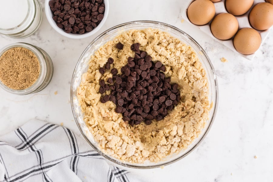 adding chocolate chips to cookie batter