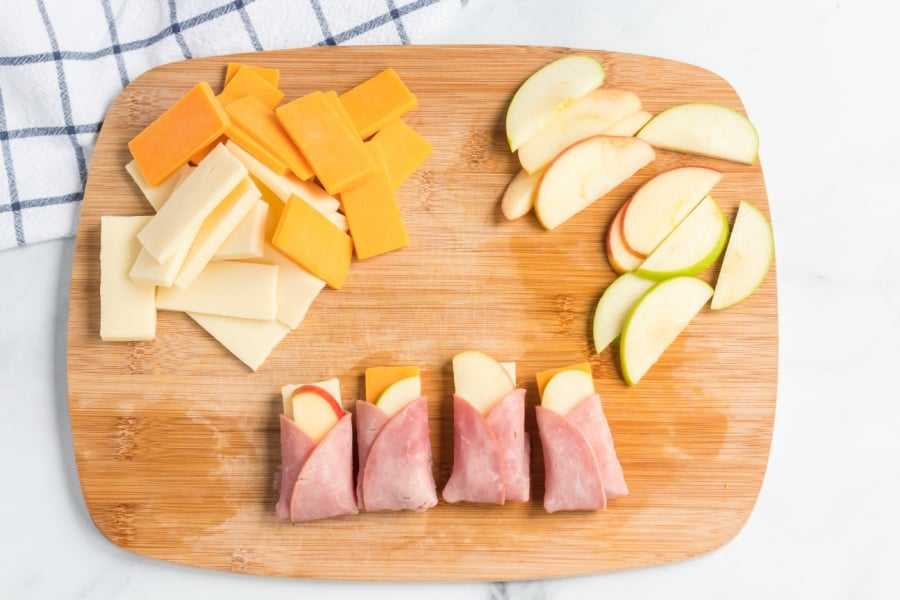 ham apple cheese wraps on a cutting board