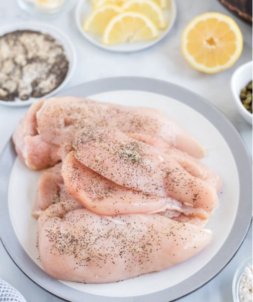 chicken breasts on plate with seasoning