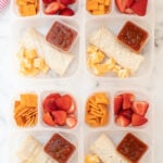 4 lunchboxes packed with burritos, strawberries, crackers, cheese and salsa-5