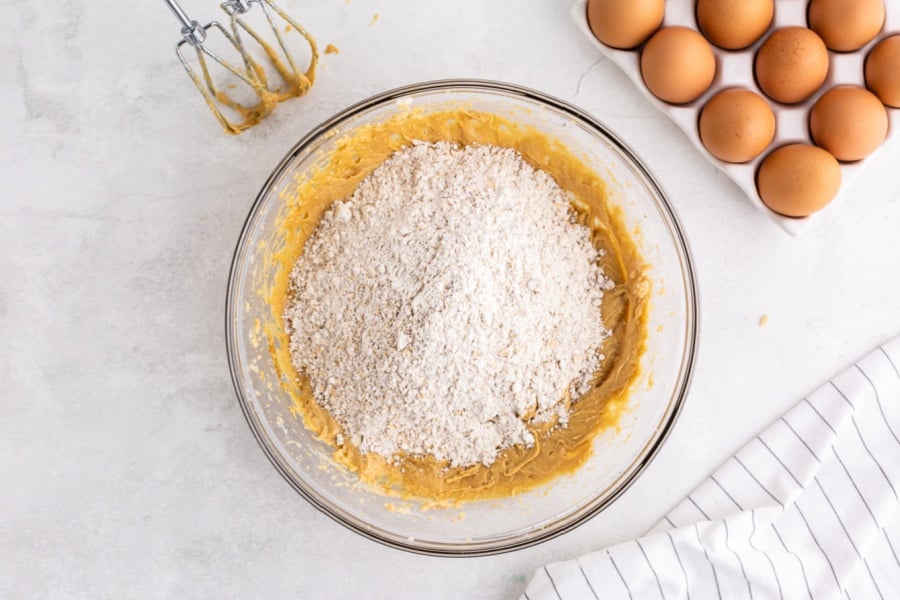 adding dry ingredients to mixing bowl