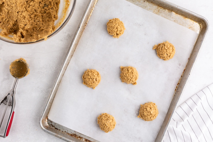 cookie dough balls on a baking sheet