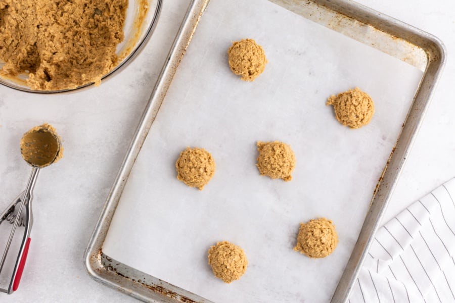 cookie dough balls on a baking sheet