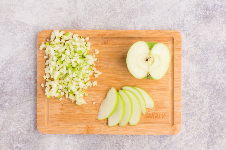 green apple chopped up on a cutting board