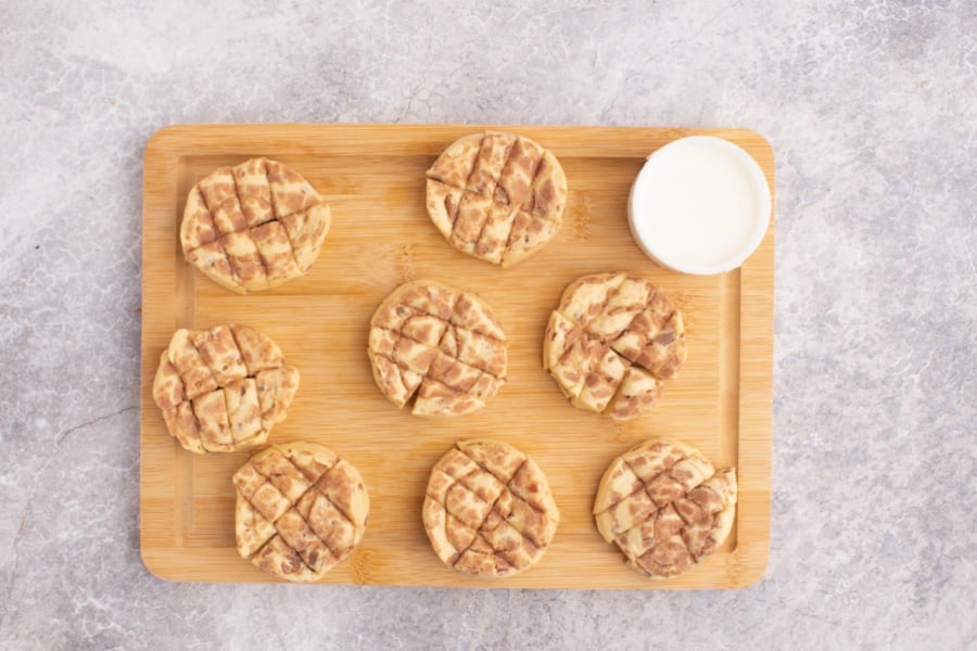 cinnamon rolls cut up on cutting board