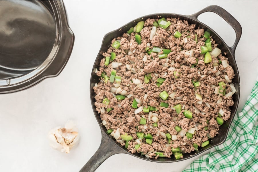 adding onion and bell pepper into pan