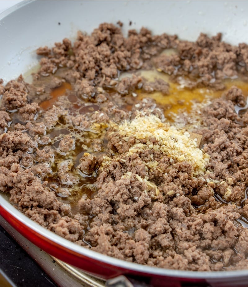 adding in onion, water bouillon, vinegar and Worcestershire sauce to pan