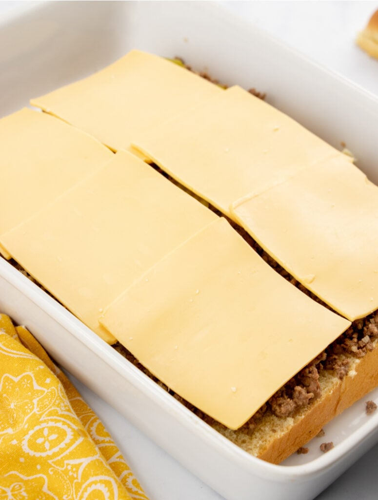 beef, pickles and sliced cheese added to baking pan