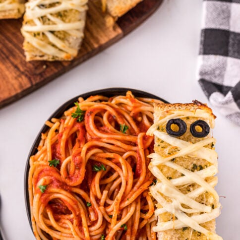 Mummy garlic bread in a bowl of spaghetti