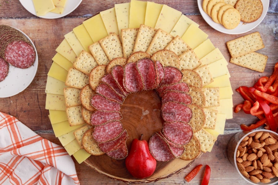 salami placed under circle crackers