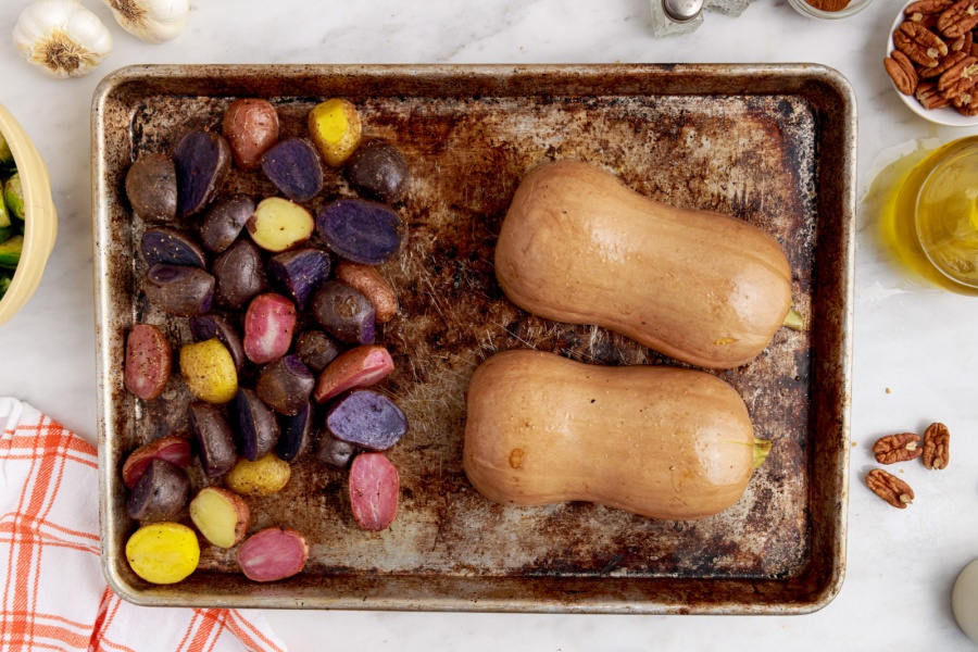 potatoes and squash on a sheet pan
