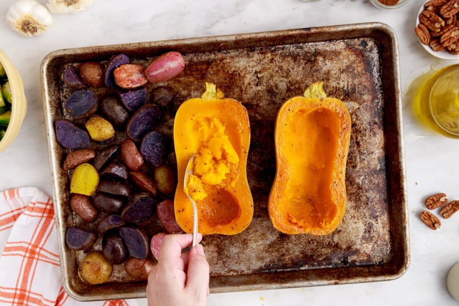 scooping out some of the squash with a spoon