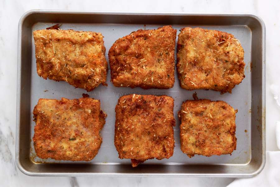 deep friend lasagna pieces on a baking sheet