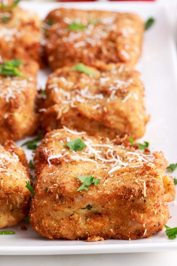 deep fried lasagna pieces on a plate