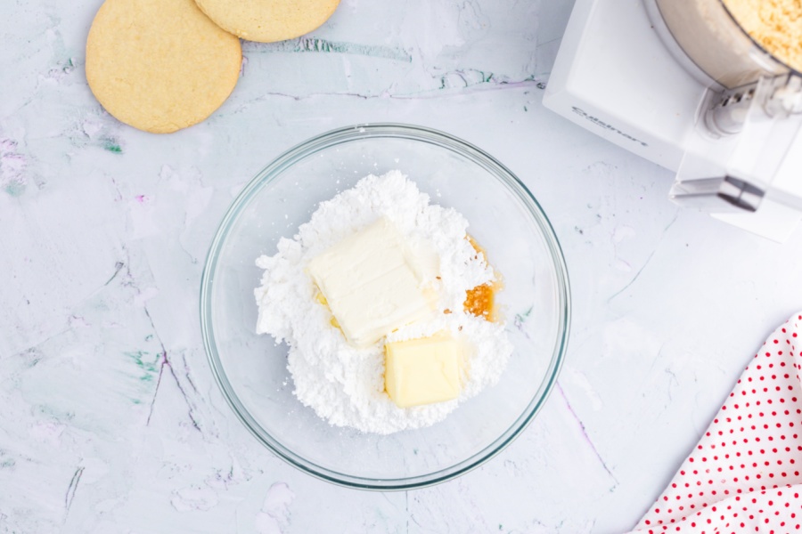 butter, cream cheese, vanilla extract, and powdered sugar in a mixing bowl