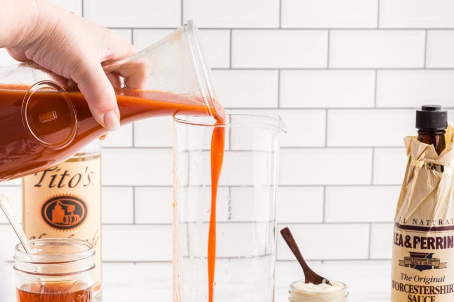 pouring tomato juice into jar