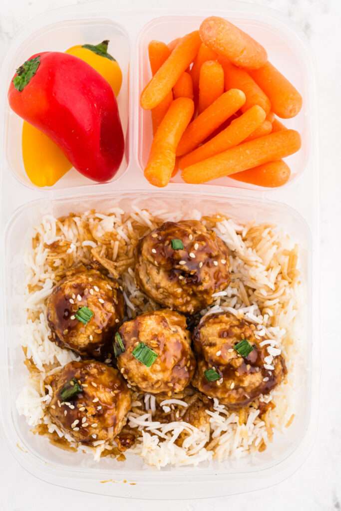 asian chicken meatballs pack in a lunchbox with carrots and peppers