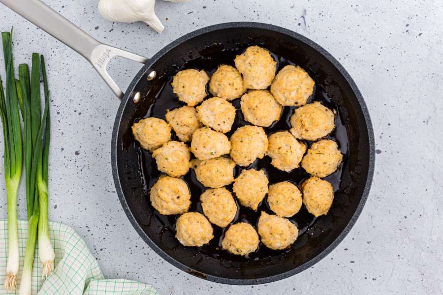 Chicken meatballs added to pan with sauce