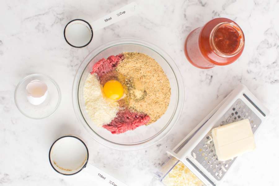 ingredients for meatballs in mixing bowl