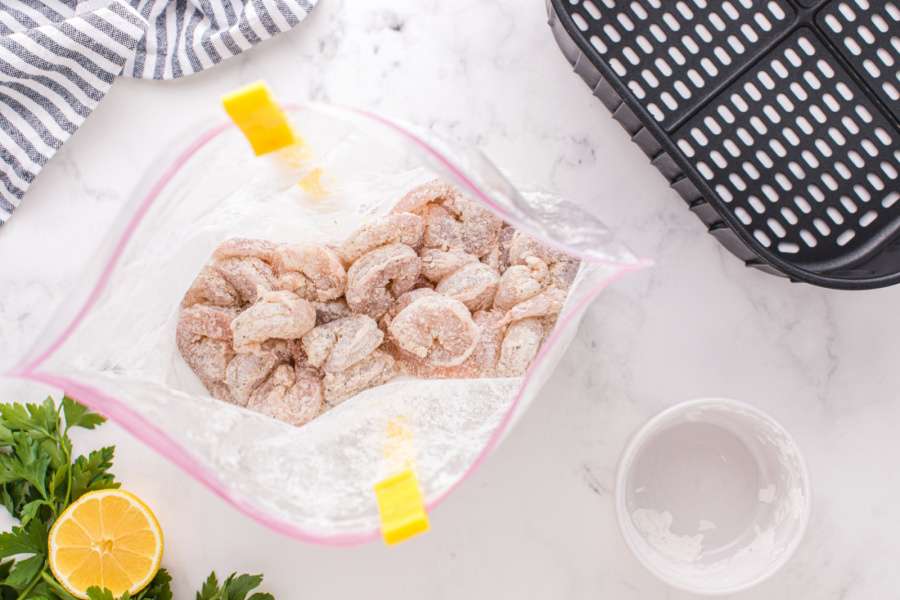 flour coated shrimp in a ziplock bag