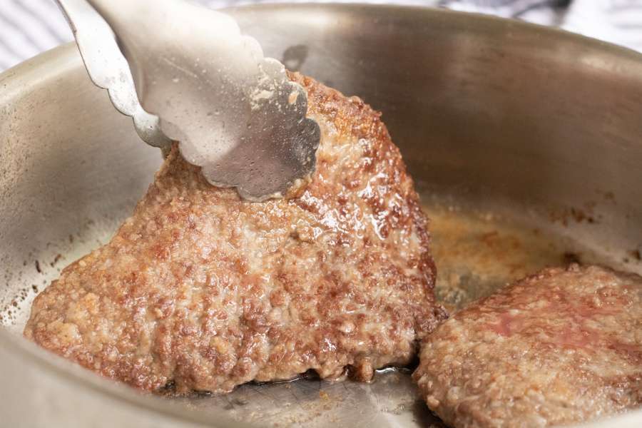frying steaks in pan