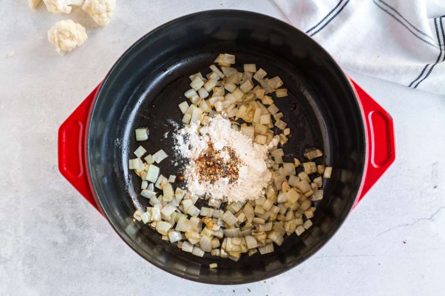 adding in butter, flour, spices, and fresh thyme to pot with onions