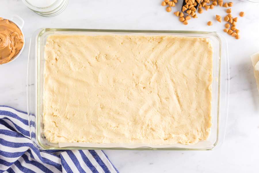 sugar cookie dough pressed into baking dish