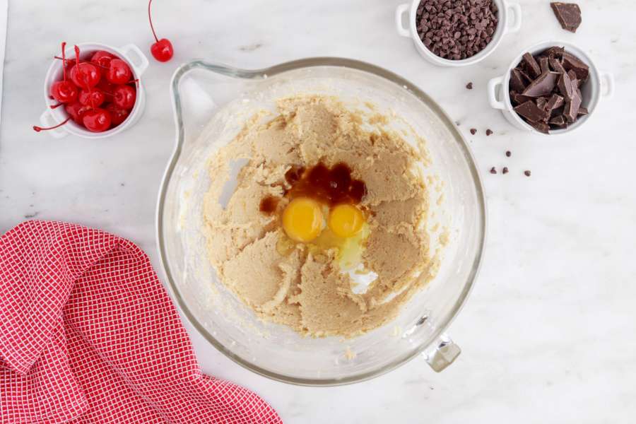 vanilla extract, almond extract, food coloring and the eggs added to bowl