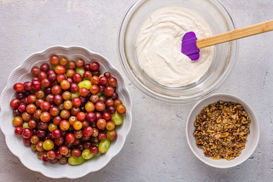 grapes in a bowl, creamy mixture in a bowl, and crunchy mix in a bowl