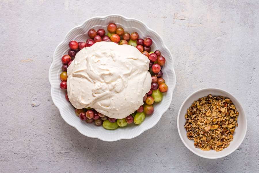 adding creamy mix into grapes