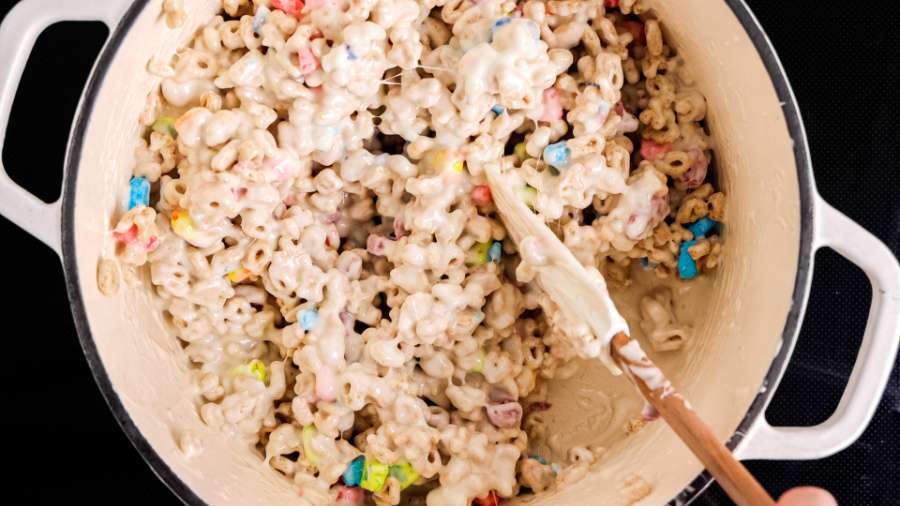 stirring cereal and melted marshmallows together