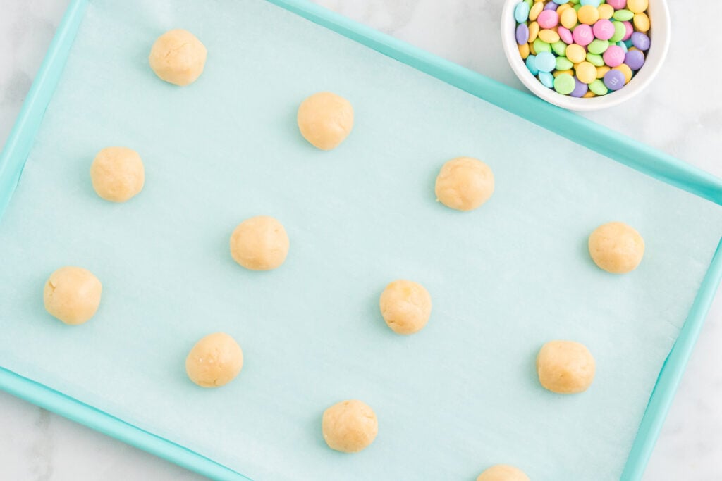 cookie dough balls on baking sheet