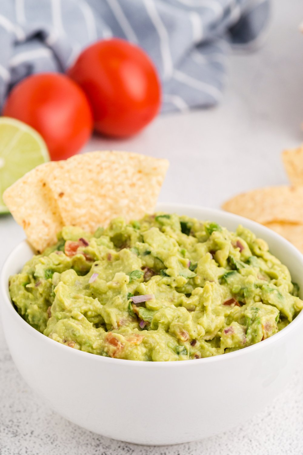 This Homemade Guacamole is so easy to make! Just chop everything up, combine it in a bowl, and mash to your preferred level of chunkiness. via @familyfresh