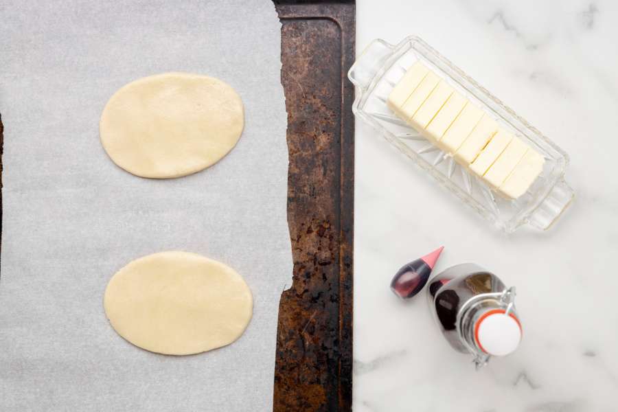 two oval cookies on baking sheet