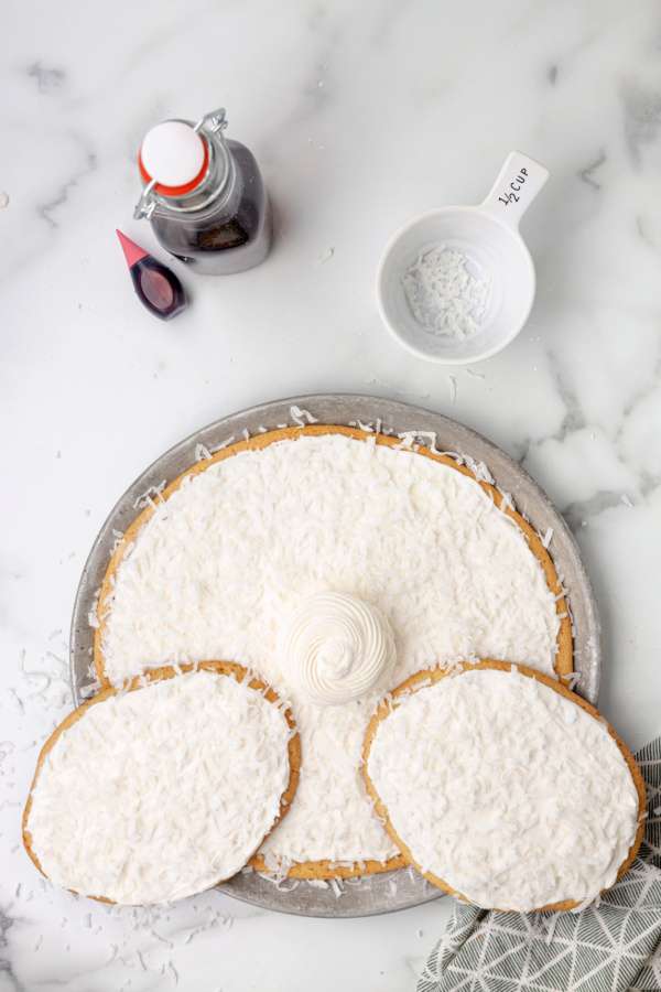 coconut and frosting tail added to cookie cake