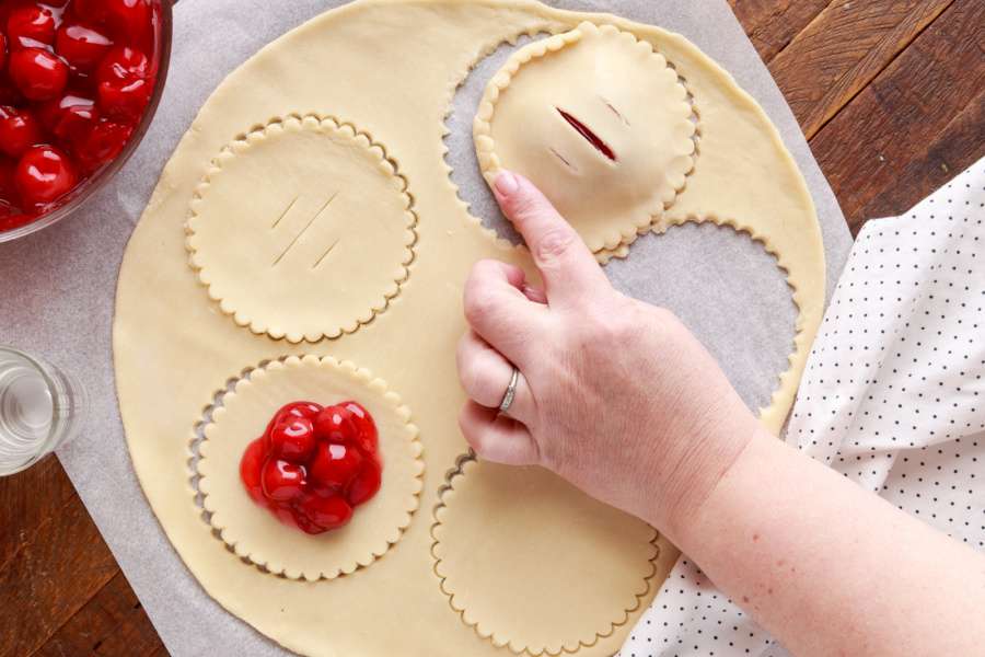 putting top crust over cherry filling
