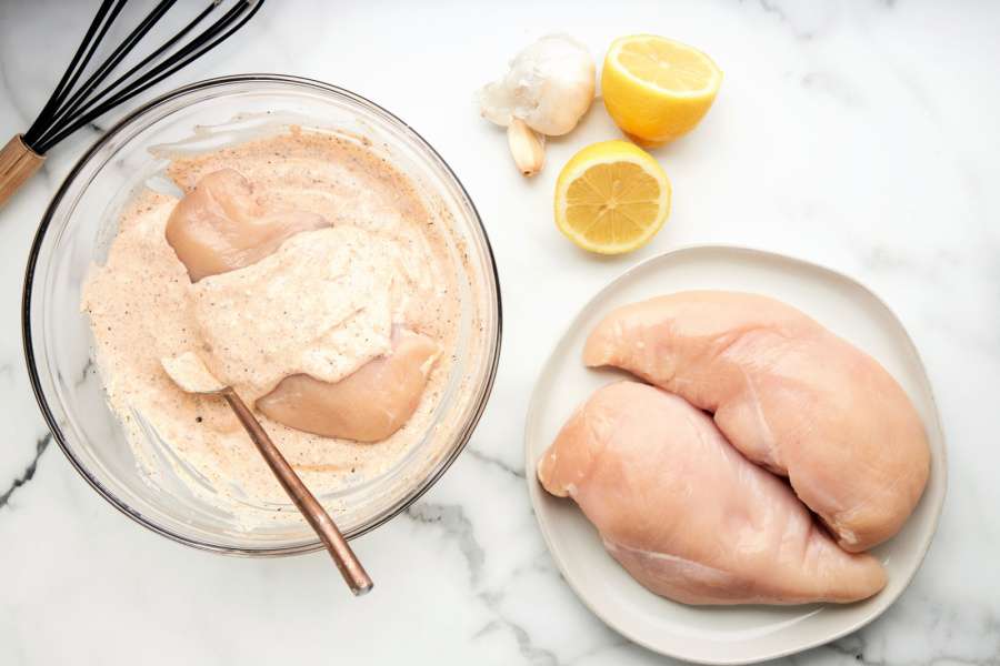 covering chicken in marinade