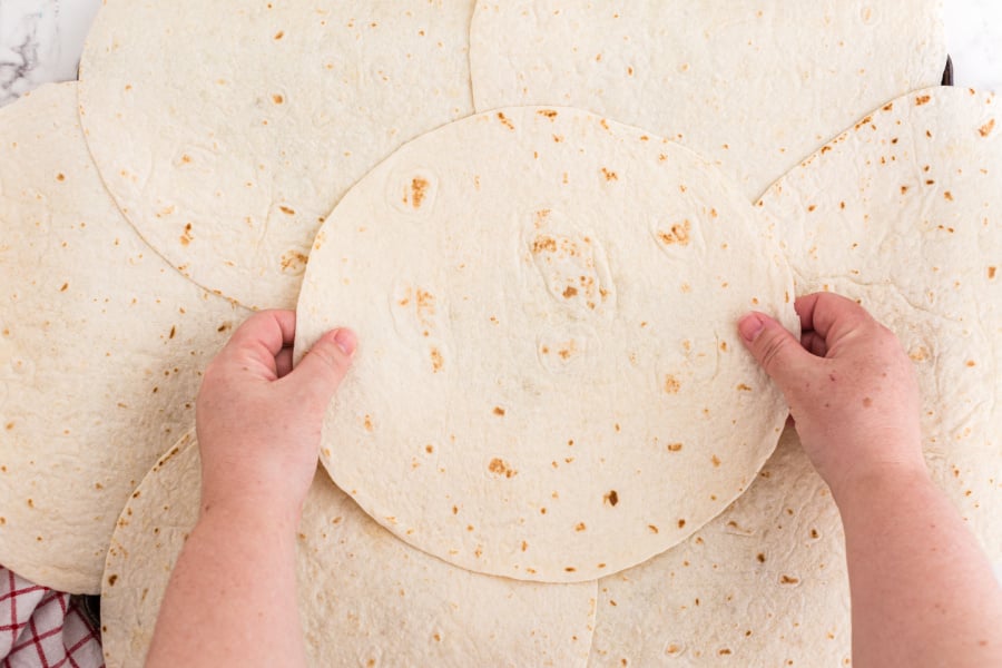 placing an additional tortilla in middle of pan
