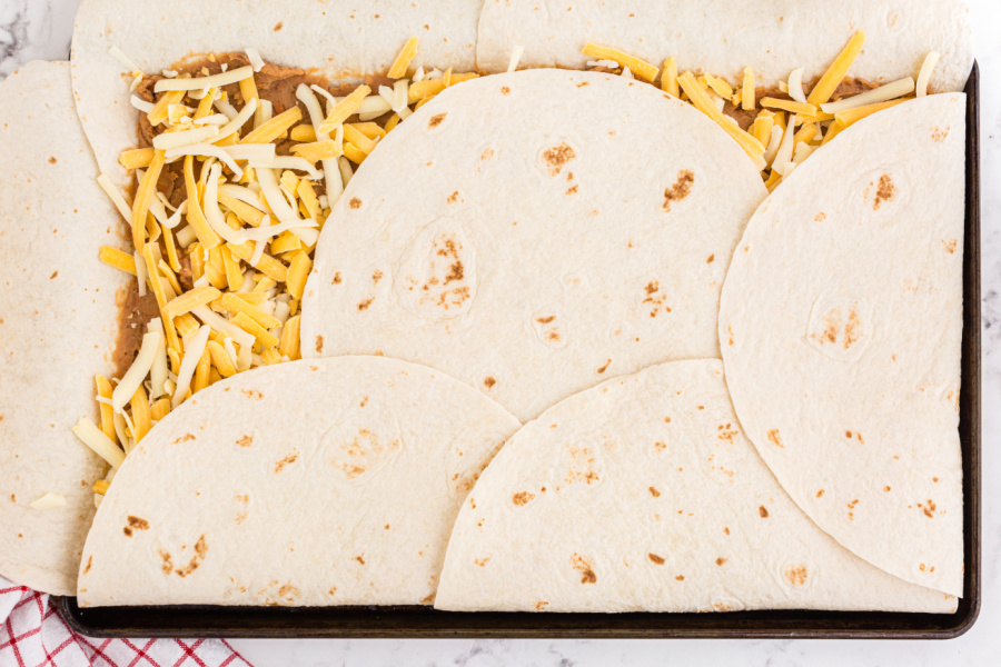 folding over handing tortillas over top